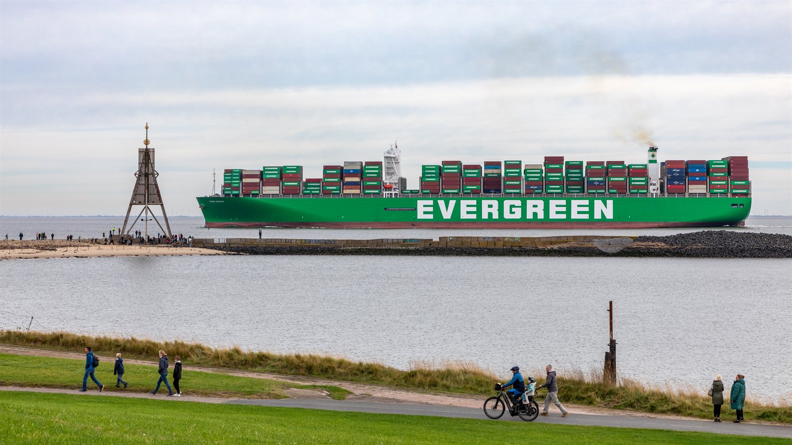 Large vessel passing the wide mouth of a river